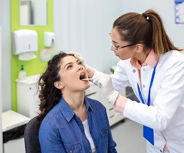 a woman is crying while sitting at a table with a doctor .