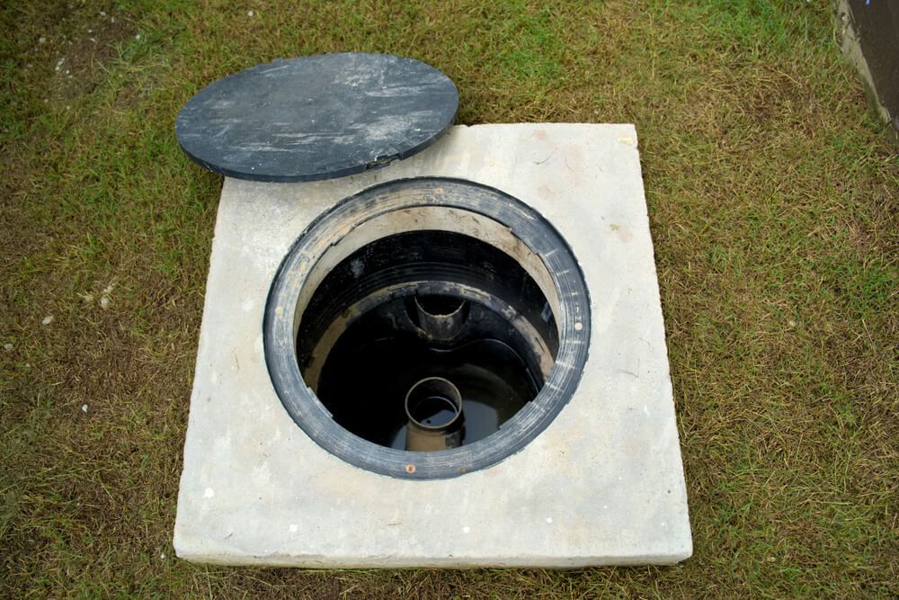 A Manhole Cover is Open and Filled With Water — Elite Wastewater Solutions in Goulburn, NSW