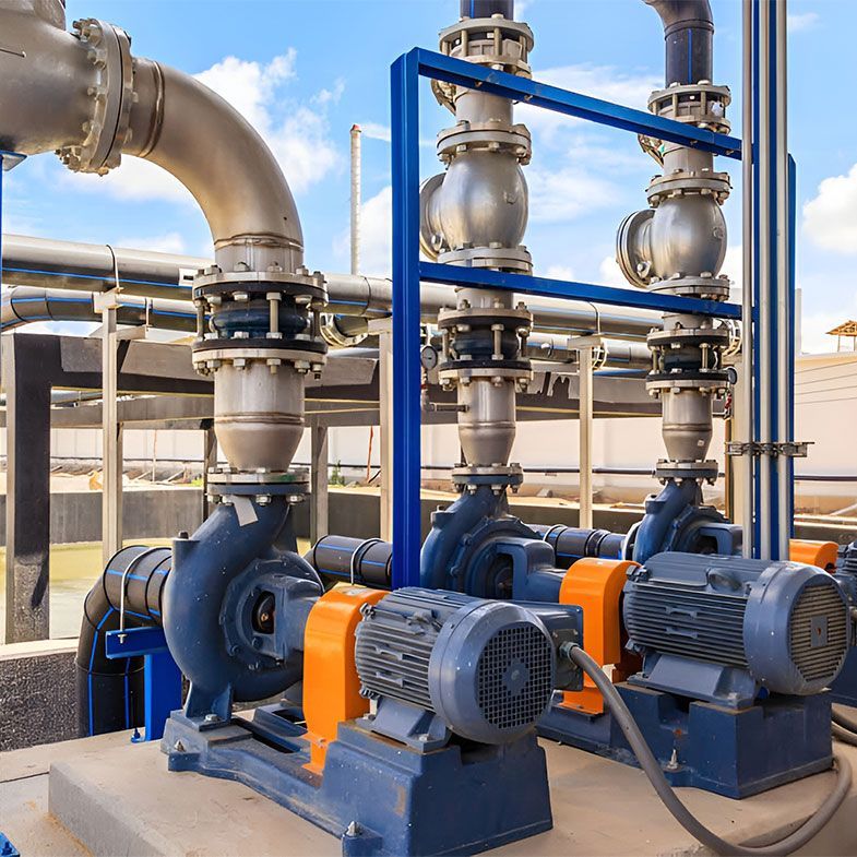 A Row of Pumps and Pipes in a Factory — Elite Wastewater Solutions in Moss Vale, NSW