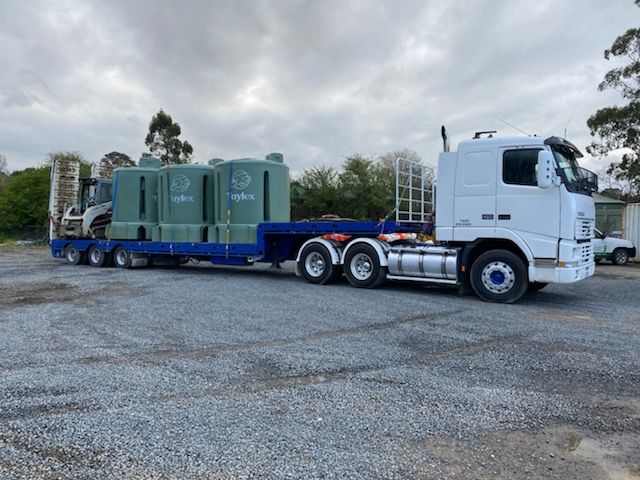 Unloading Heavy Truck Loaded with Septic Tank — Septic Tank in the Southern Highlands
