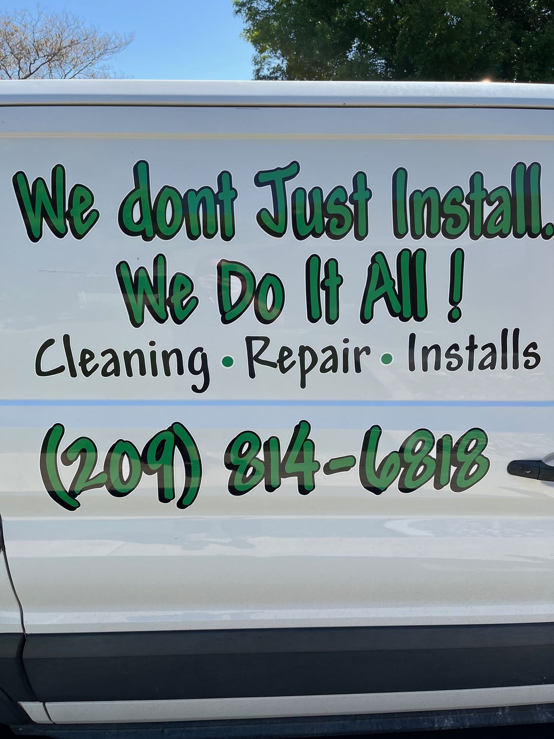 A white van with a sign that says we dont just install we do it all