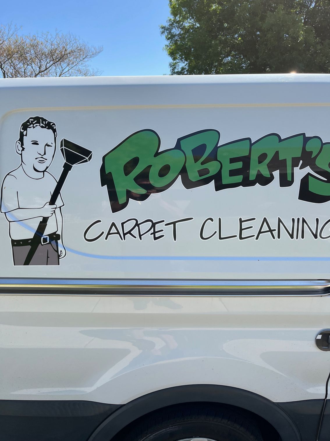 A white van with robert 's carpet cleaning written on the side