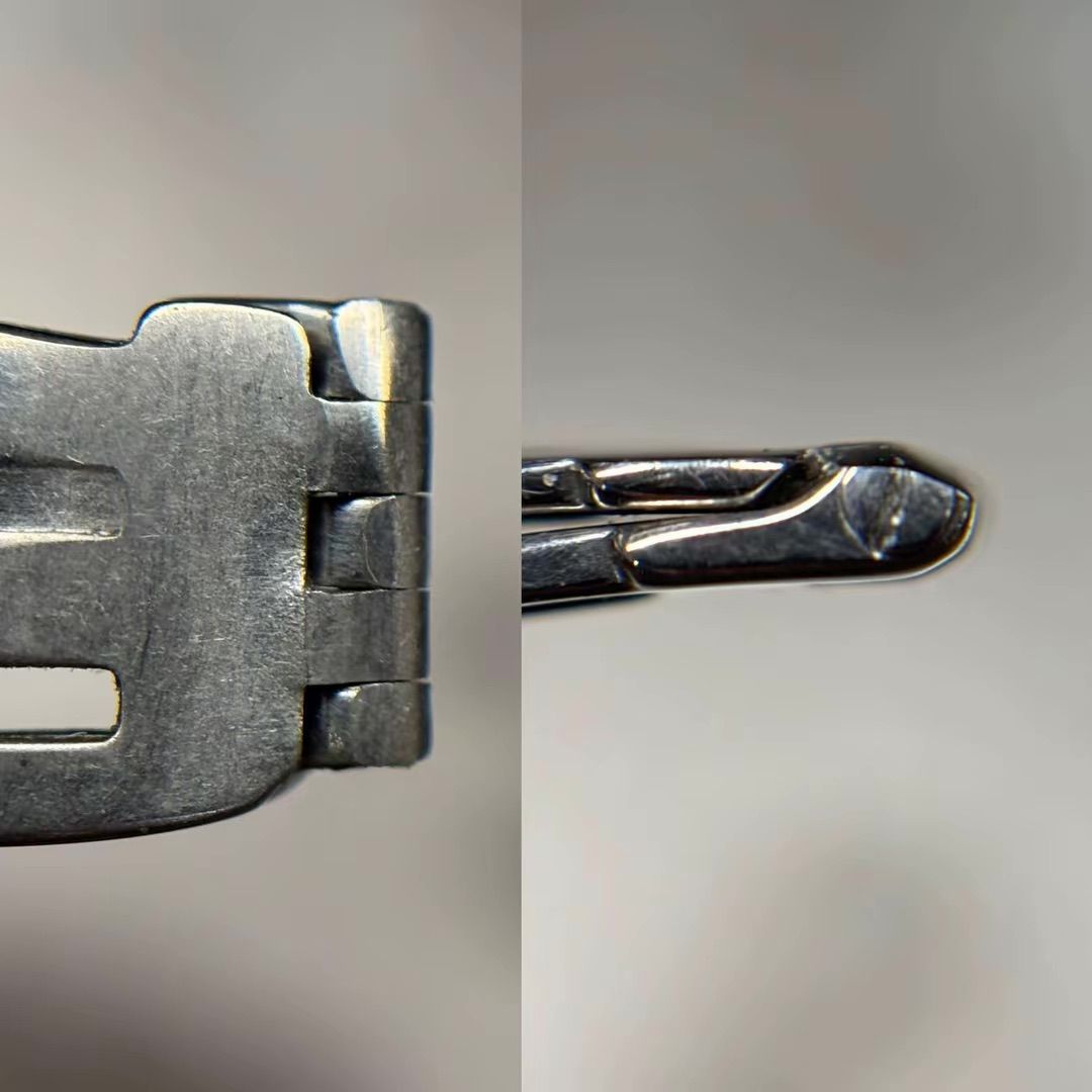 Primo piano della cerniera del bracciale di un orologio in argento e del meccanismo di chiusura in metallo.