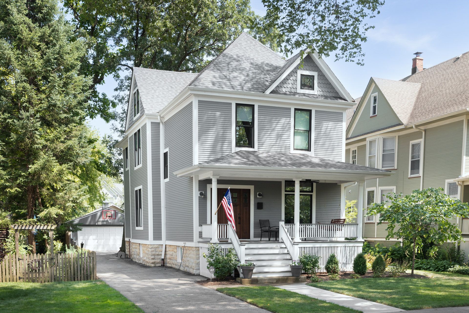 A house with a porch and a flag on it