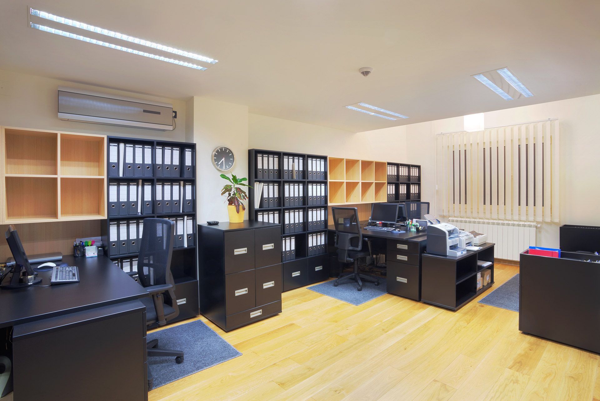 A large office with a lot of desks and shelves