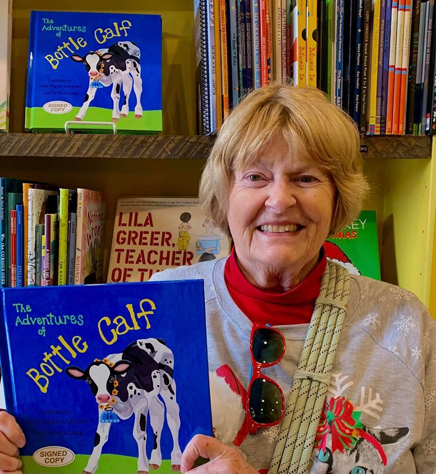 A woman is holding a book titled bottle calf