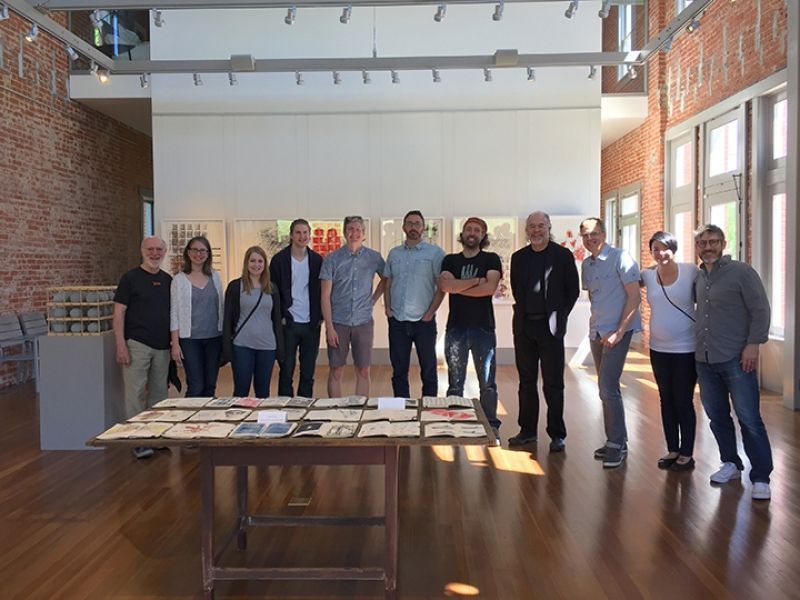 A group of people are posing for a picture in a room.