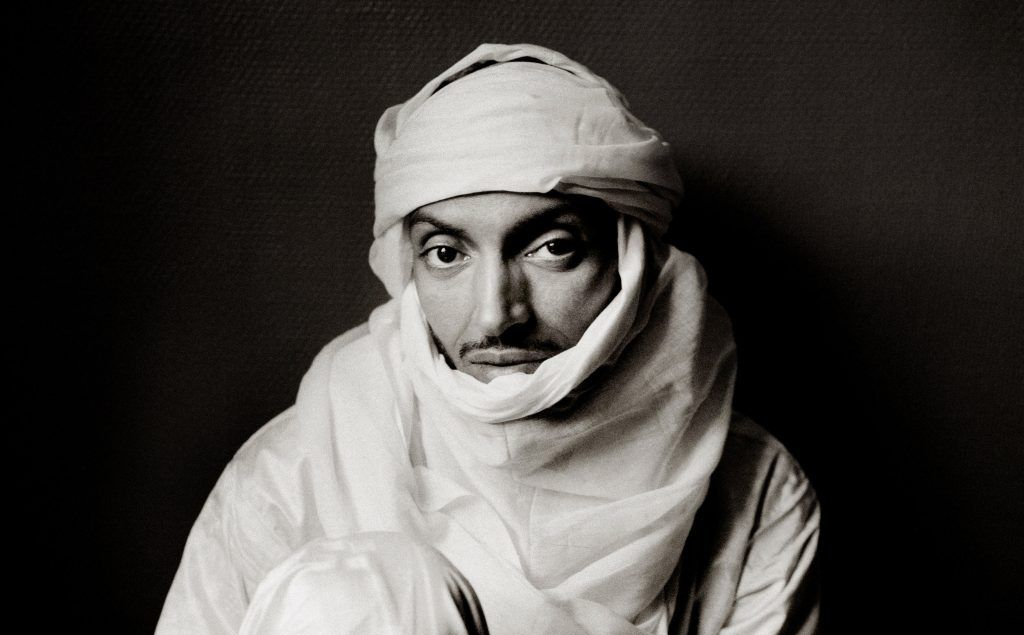 A black and white photo of a man wearing a turban