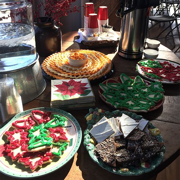 Table with cookies, drinks, and snacks; festive holiday gathering.