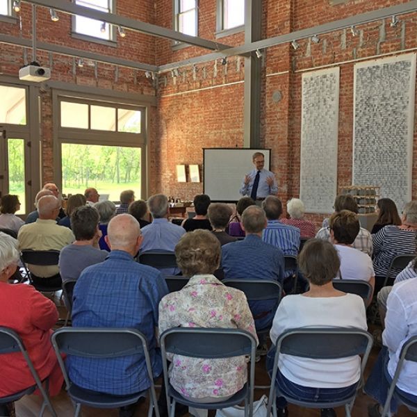 A man is giving a presentation to a group of people