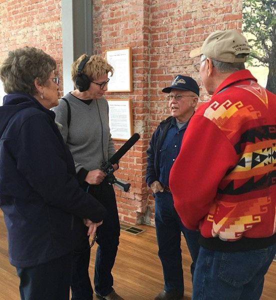 A group of people standing in front of a brick wall