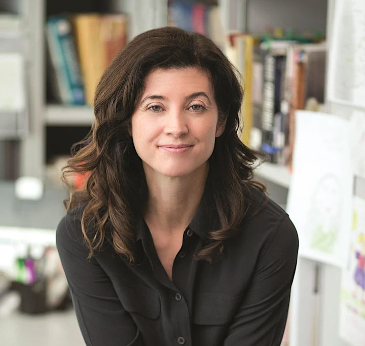 a woman headshot with a blurred background