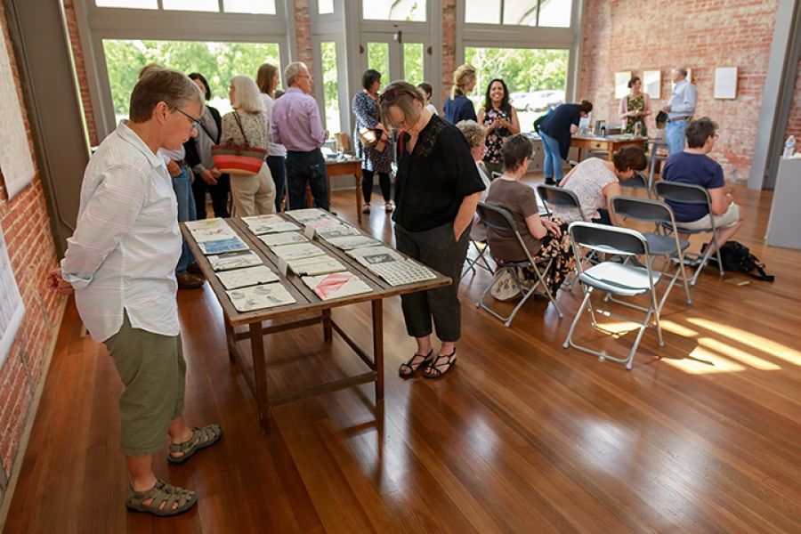 A group of people are standing around a table in a room.