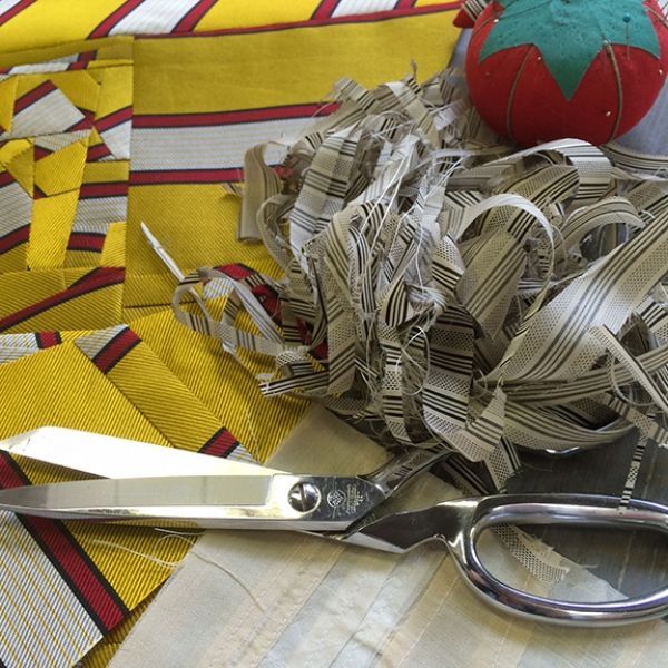 A pair of scissors sitting on top of a pile of ribbons
