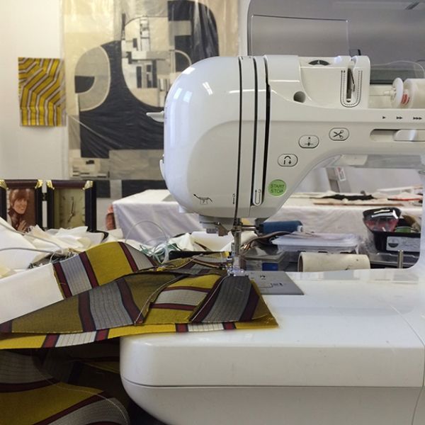 A white sewing machine is sitting on a table