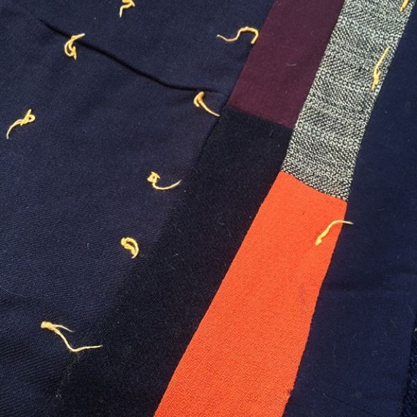 A bunch of different colored fabrics with letters on them