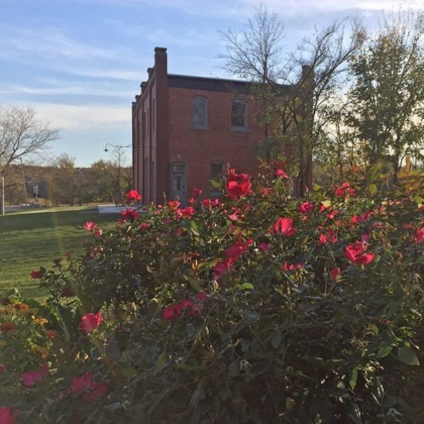 A brick building with flowers in front of it