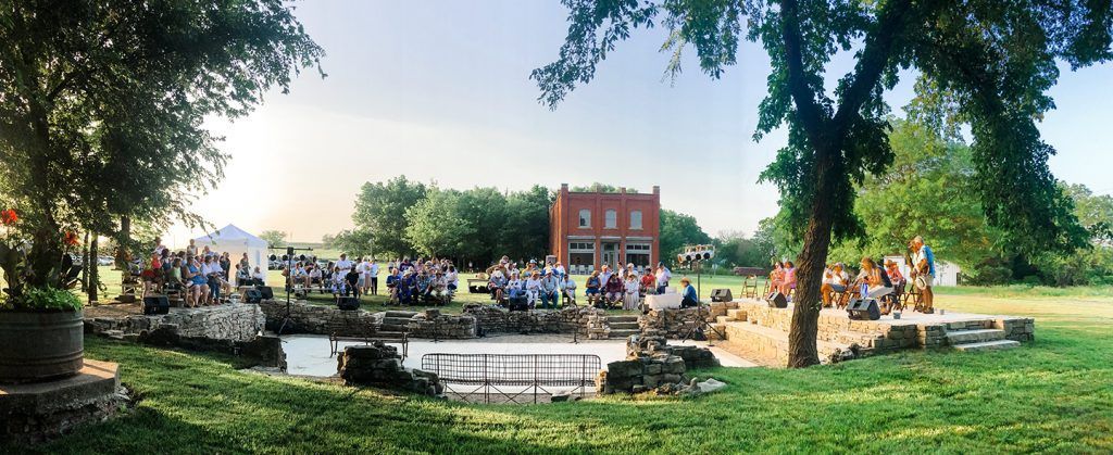 A large group of people are gathered in a park.