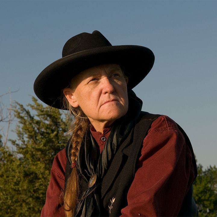A woman wearing a black hat and a red shirt