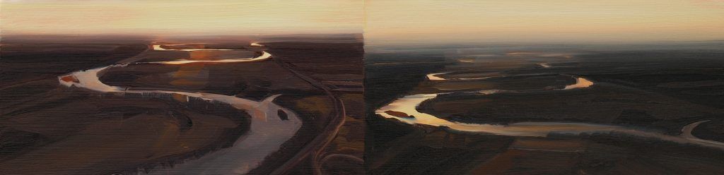 An aerial view of a river flowing through a forest at sunset.