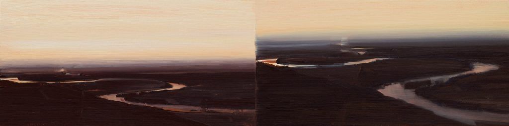 A blurry picture of a landscape with a sunset in the background.