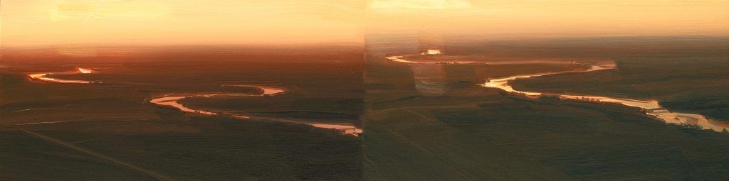 An aerial view of a city at sunset.