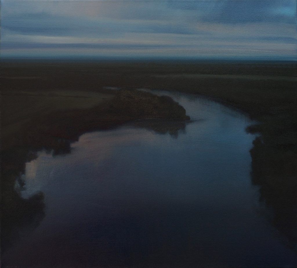 An aerial view of a river with a small island in the middle
