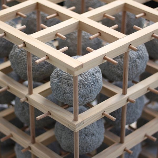 A wooden cage filled with balls of different sizes