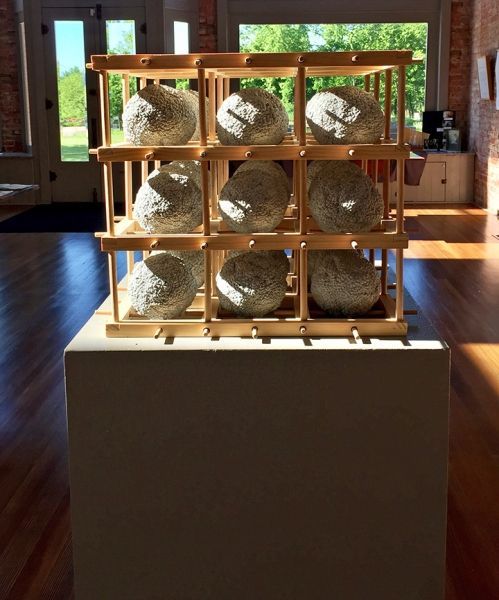 A display of rocks in a wooden cage