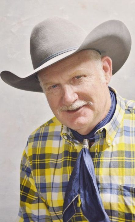 A man wearing a cowboy hat and a plaid shirt