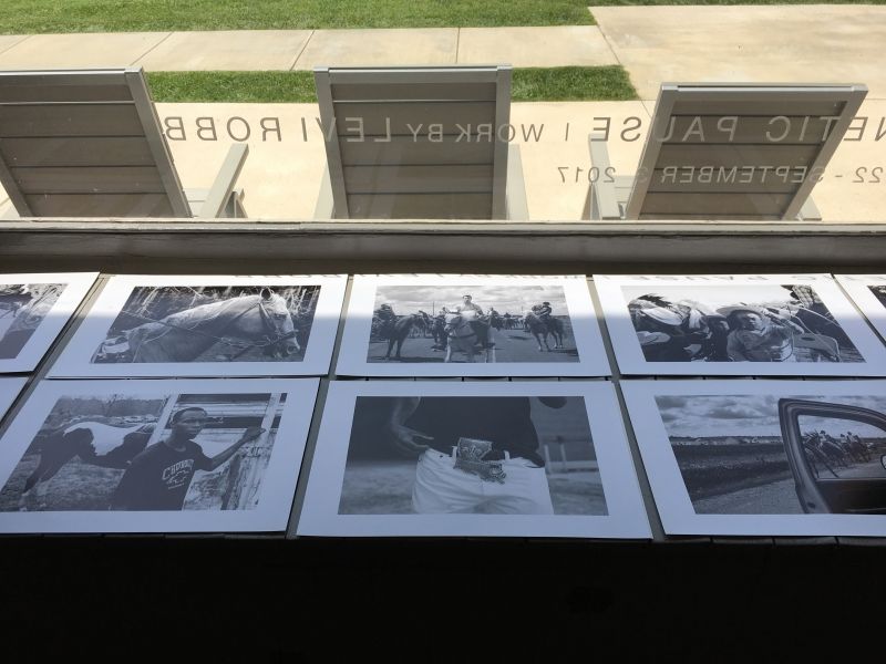 A bunch of black and white photos on a table
