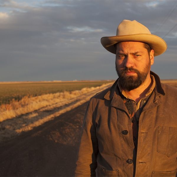 A man with a beard wearing a cowboy hat