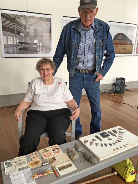 A man and a woman are standing next to each other in a room.