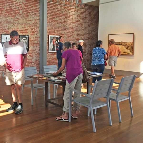 A group of people are standing around a table in a room