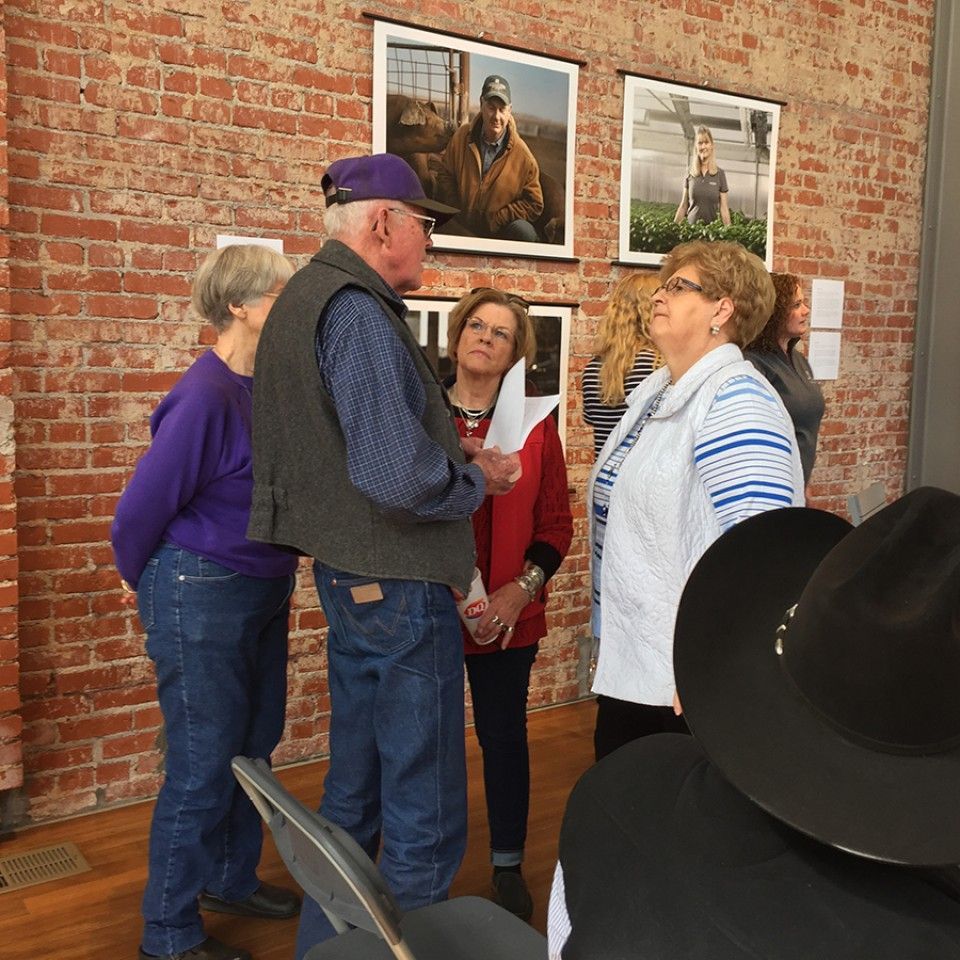 A group of people standing in front of a brick wall