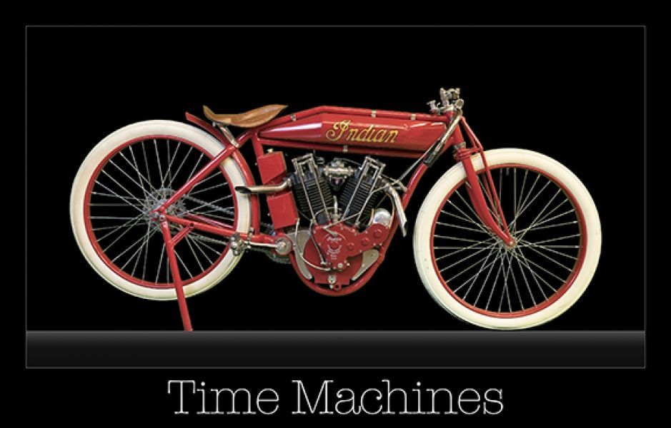 A picture of a red indian motorcycle with white wheels