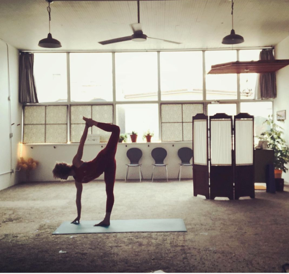 A person is doing a yoga pose in a room