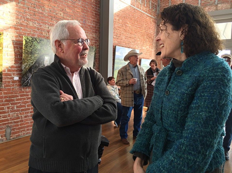 A man and a woman are talking to each other in a room.