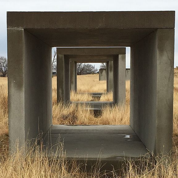 A row of concrete blocks in a field of dry grass