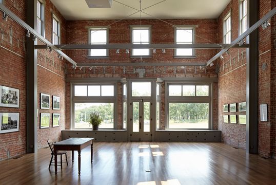 A large room with a table and chairs in it