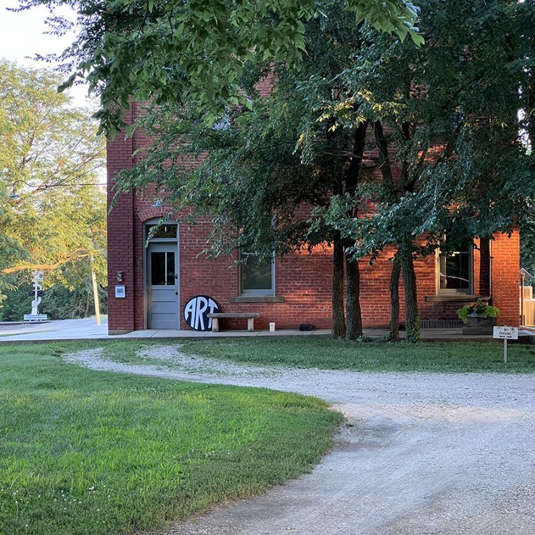 A brick building with a sign that says art on it