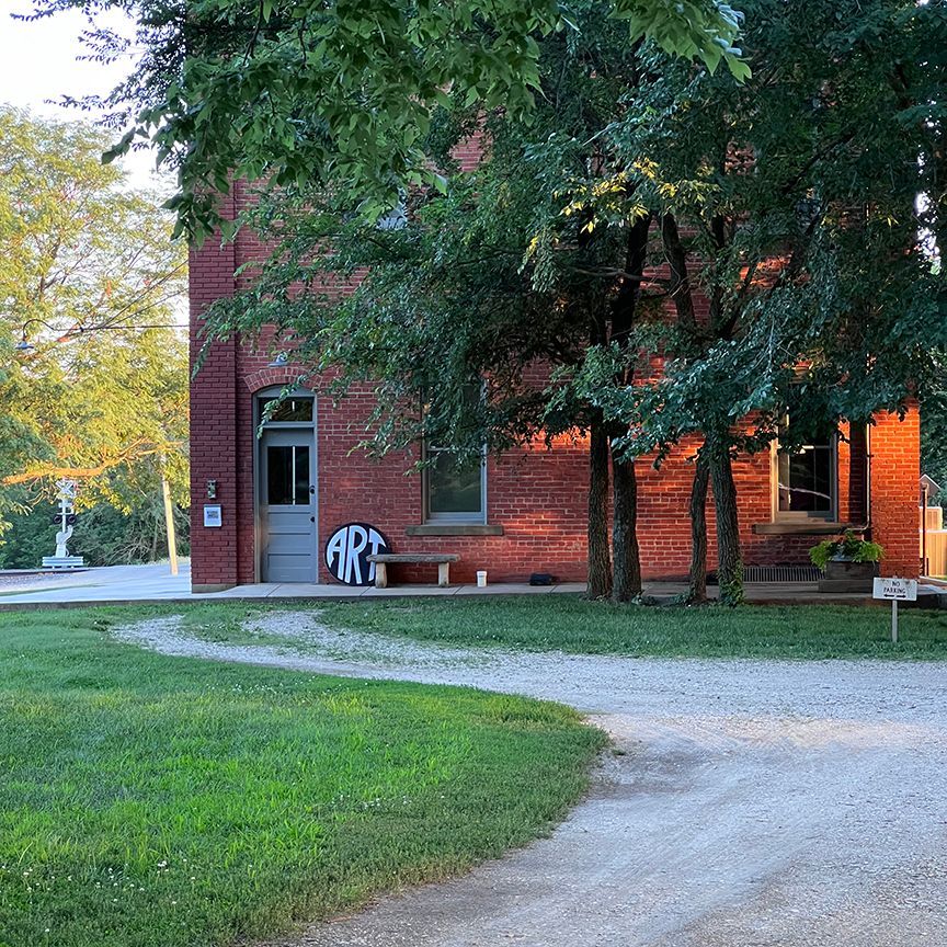 A brick building with a sign that says art on it