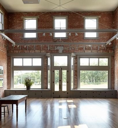 A large room with lots of windows and a table
