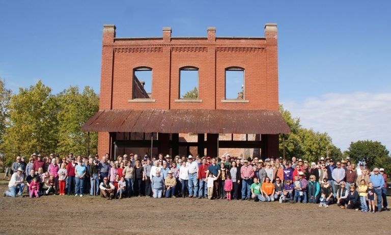 A large group of people standing in front of a brick building
