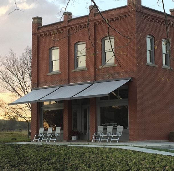 A brick building with a white awning on the front