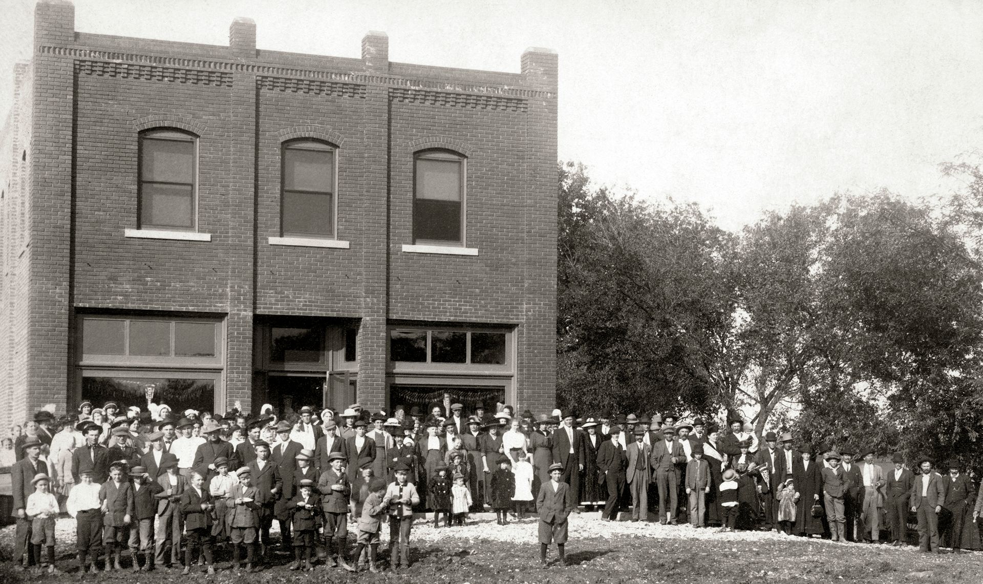 A group of people standing in front of a brick building