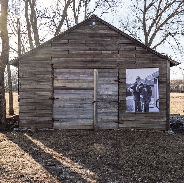 A wooden shed with a picture on the side of it