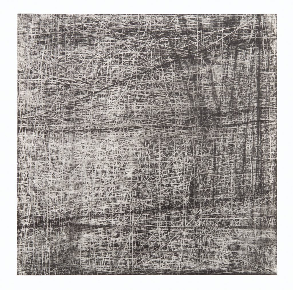A close up of a gray and white rug on a white background.