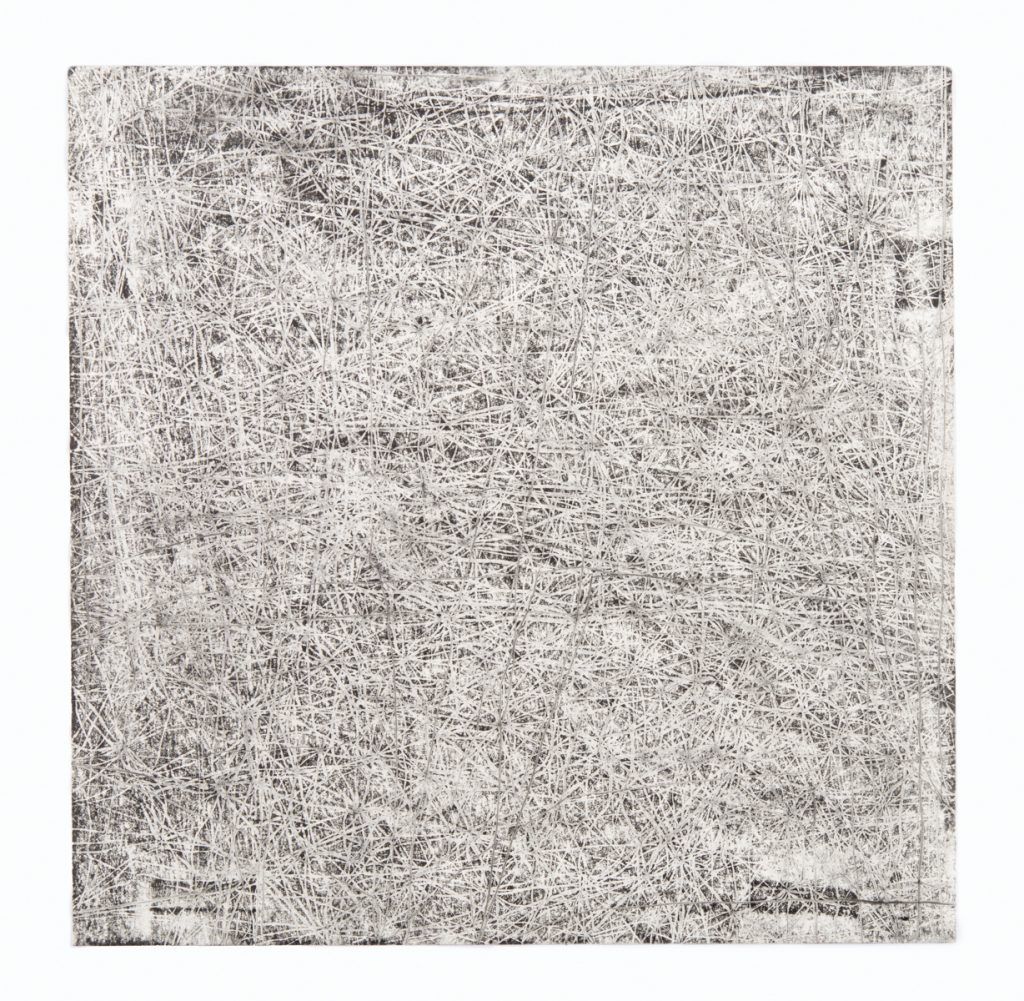 A close up of a gray and white carpet on a white background.