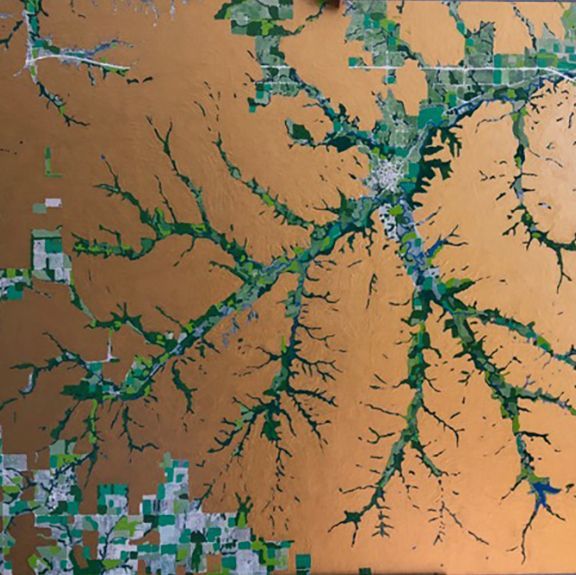 Aerial view, gold and green abstract landscape. River-like green formations, scattered green patches.